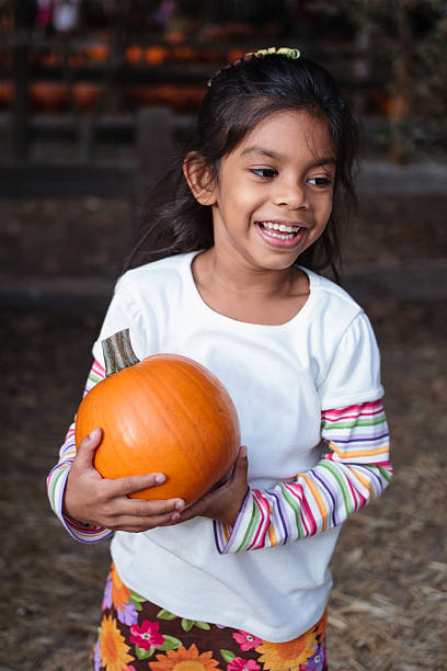istock Happy girl embracing a pumpkin 157091581