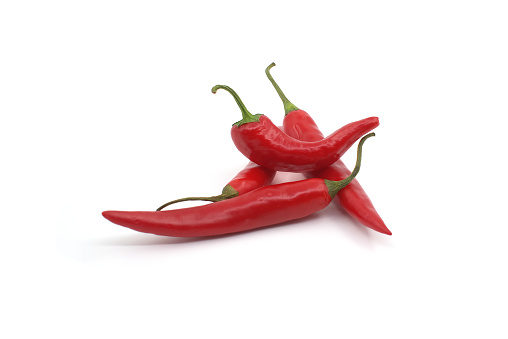 Group of red chili peppers freshly picked from the garden arranged on white background