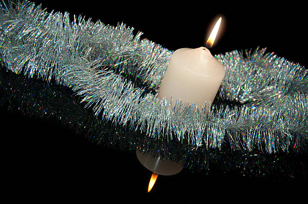 Burning candle with Christmas-tree decoration stock photo