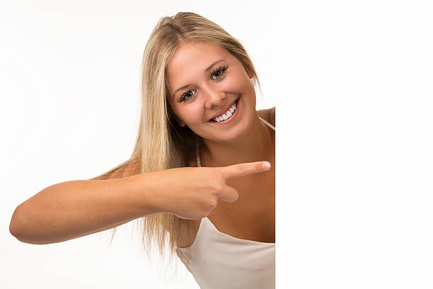 istock Beautiful Young Woman Showing A Blank Sign 157096757