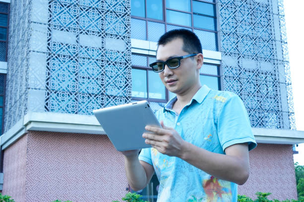 istock Businessmen use tablet computers under office buildings 1570987813