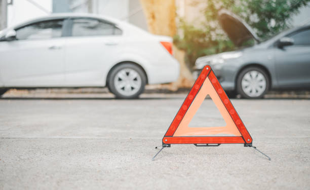 istock red emergency triangle on the road indicates that there is an accident or car breakdown on the road ahead. 1571006678