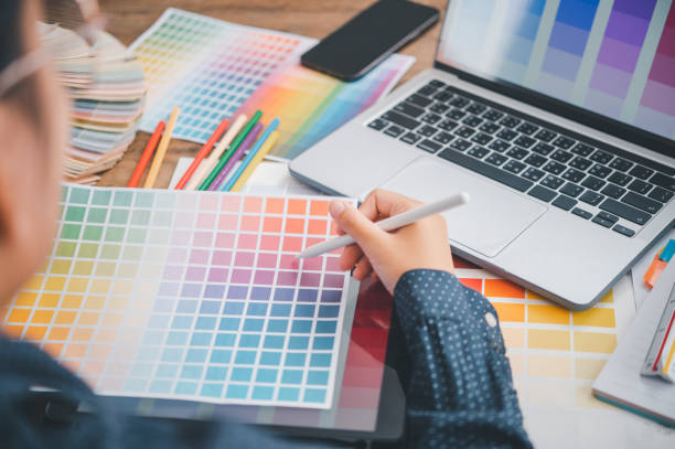 istock Graphic designer architects who work with laptops and color comparison tables for design work. 1571025491