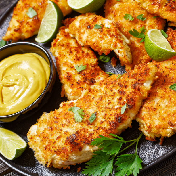 istock fried chicken cutlets on black plate, top view 1571041645