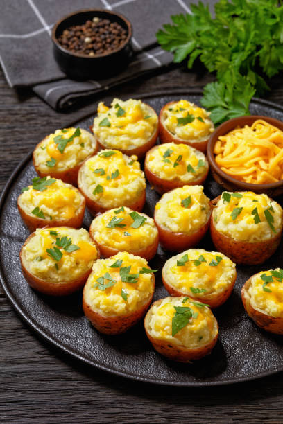 istock baked stuffed red potatoes on black plate 1571043518