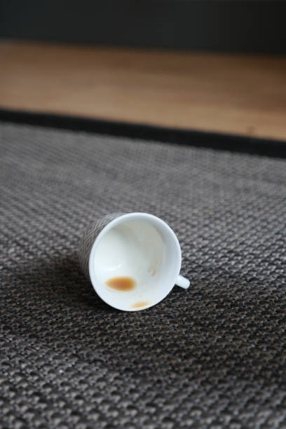 istock cup of coffee spilled on gray color carpet 1571057579