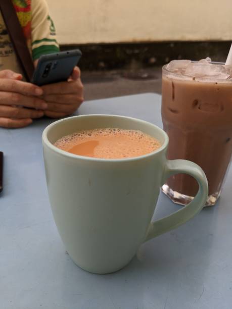 istock close up of breakfast with hot tea or teh tarik and egg bread 1571059113