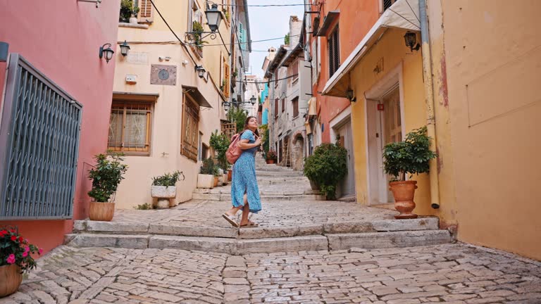 SLO MO Young Tourist Woman with Backpack Walking through the Streets of Rovinj in Istria