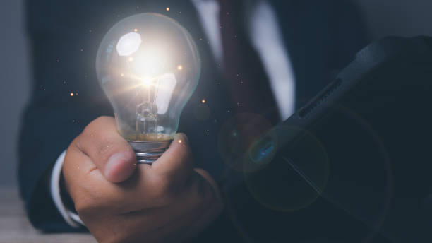 istock Businessman with light bulbs the new ideas and creative. 1571064103