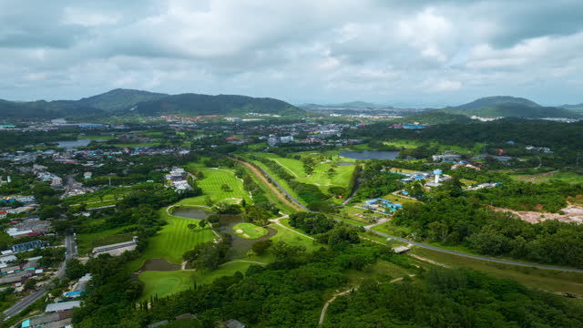 Aerial Drone video hyperlapse of golf course with road in kathu city Phuket thailand,Amazing timelapse 4K Hyperlapse drone view
