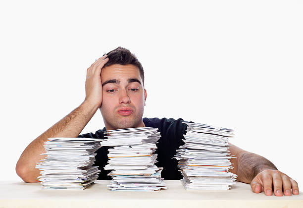 istock Financial Problems, Young Man with Paperwork Overload and Unpaid Bills 157106649