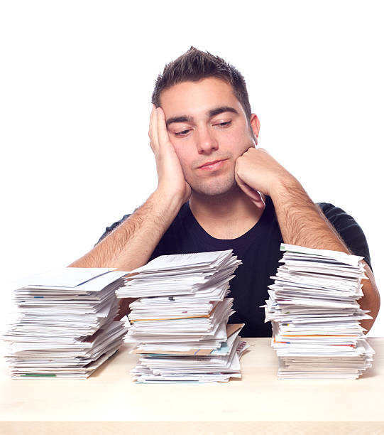 istock Financial Problems, Young Man with Paperwork Overload and Unpaid Bills 157106685