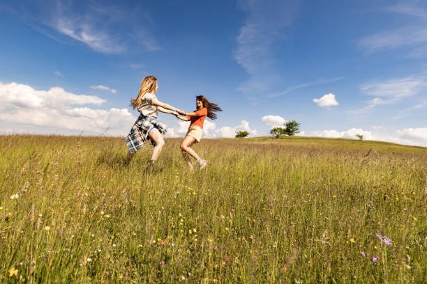 istock Carefree women spinning during spring day in nature. 1571072781