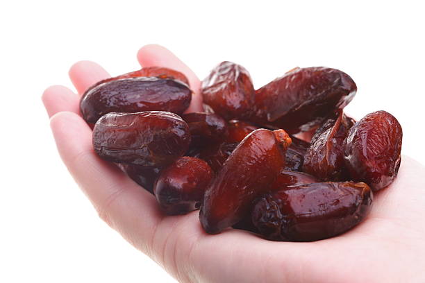 istock Dried date fruits in palm isolated 157107613