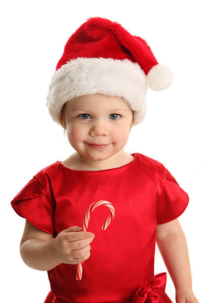 Cute young female child with a holiday candy cane stock photo