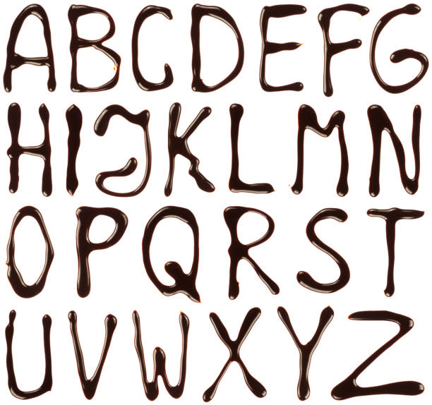 istock Alphabet letters written with chocolate syrup on white background 157109541