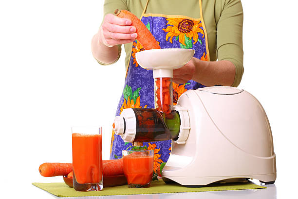 istock woman prepare Juice extractor and carrot 157109835