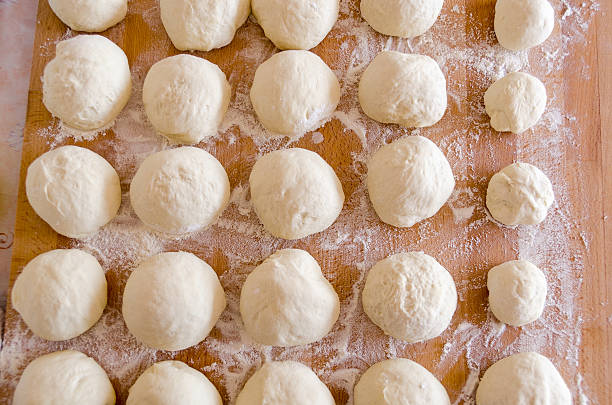 istock pizza dough on wooden cutting board 157111231