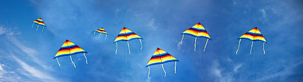 A lot of colorful kites on the background of a cloudy sky with clouds
