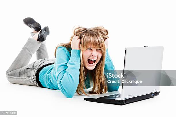 Stressed And Angry Female Teenager Shouting At Her Laptop Stock Photo - Download Image Now