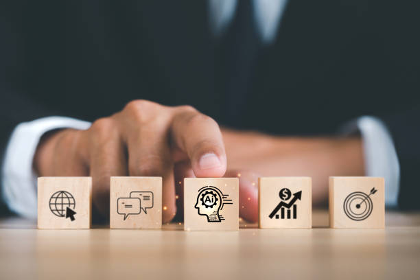 istock Ai technology, Artificial Intelligence. Businessman hand holding wooden cube with Ai icon, Artificial Intelligence to help solve work problems and improve the efficiency of work. Futuristic technology 1571147272
