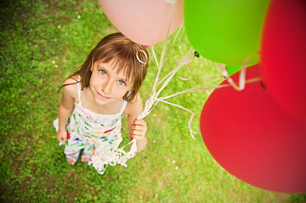 Happy little girl with balloons.