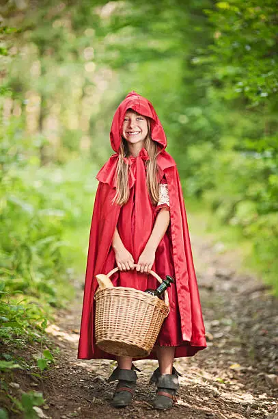 Little Red Riding Hood standing on the forest path. Slightly soft.