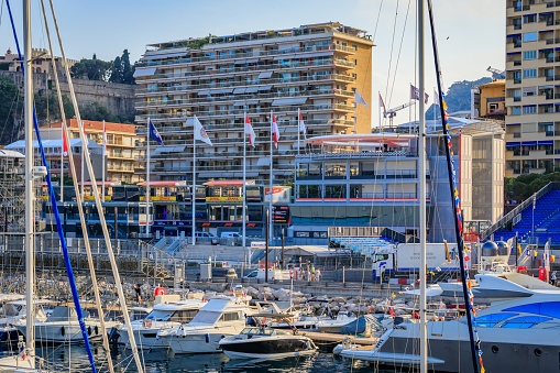 Monte Carlo, Monaco - May 24, 2023: Luxury yachts and empty grand stands tribunes in Yacht Club marina harbor for the Monaco Grand Prix F1 race