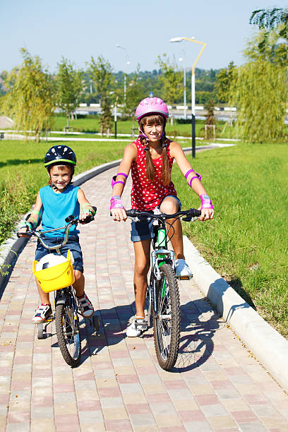 istock Kids riding bikes in park 157121038