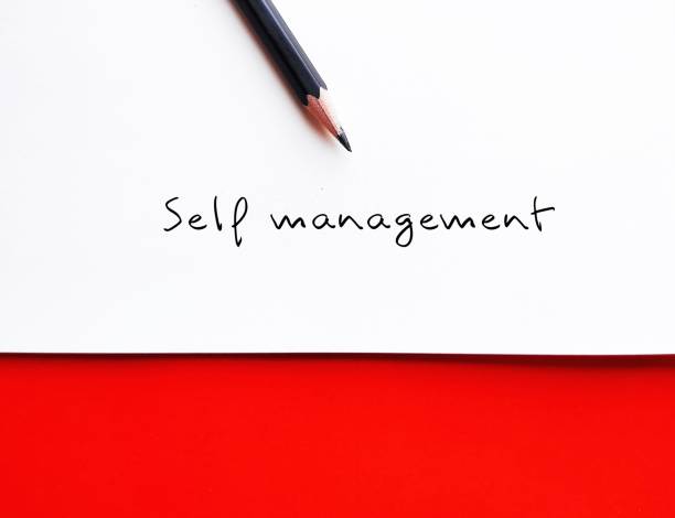 istock White paper on red background  with pencil handwritting SELF MANAGEMENT, ability to regulate thoughts, behaviors and emotions in productive way 1571219233