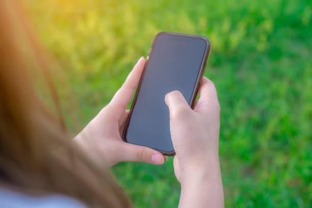 istock Hand women with smartphone mobile online social network 1571221331