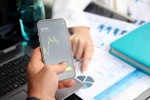 istock Businessman using a mobile phone for buying a crypto online in the office 1571245334
