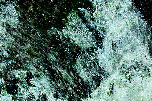 Rushing water in Andrews Brook, stopped in action with high speed flash, on Mt. Sunapee in Newbury, New Hampshire.