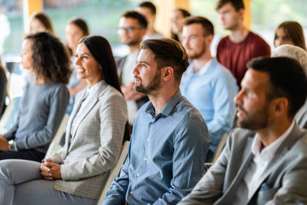 istock Business people having a seminar in board room. 1571250804