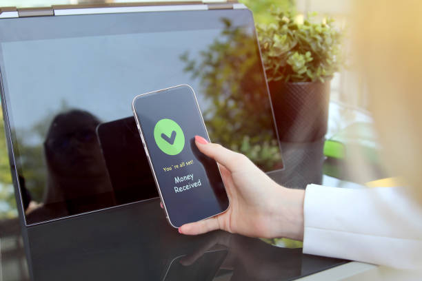 istock Woman is holding  a smartphone with  statement that money received. 1571251905
