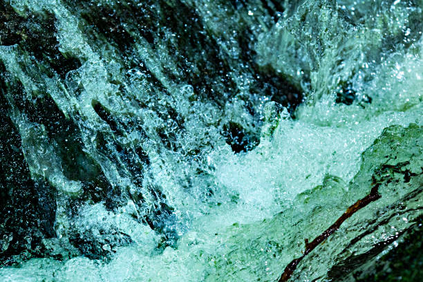 Rushing water in Andrews Brook, stopped in action with high speed flash, on Mt. Sunapee in Newbury, New Hampshire.