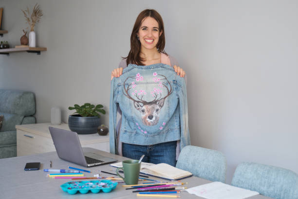 Portrait of an artist and entrepreneur woman smiling and showing her art design. stock photo