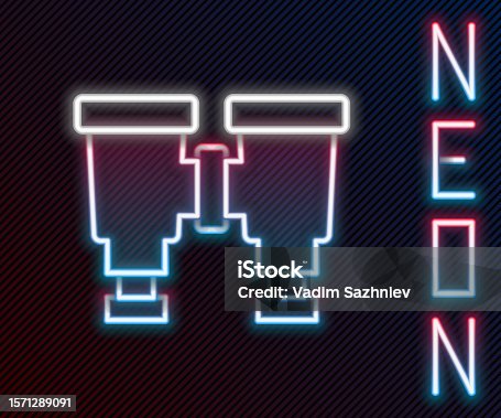 istock Glowing neon line Binoculars icon isolated on black background. Find software sign. Spy equipment symbol. Colorful outline concept. Vector 1571289091