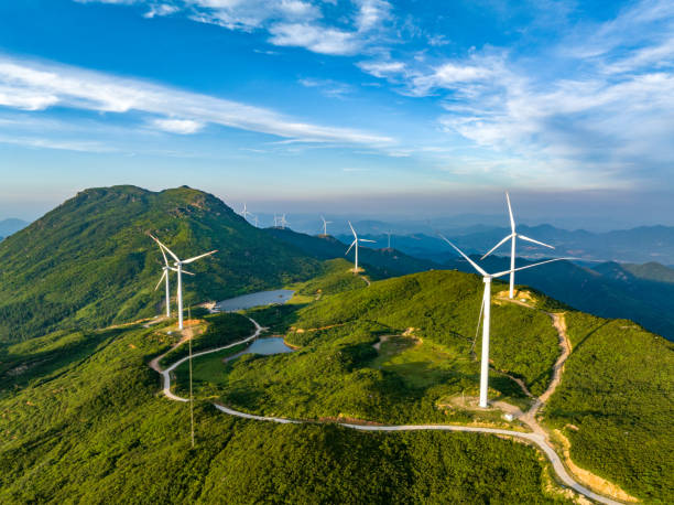 istock Wind farm on the mountain, blue sky and white clouds 1571295512