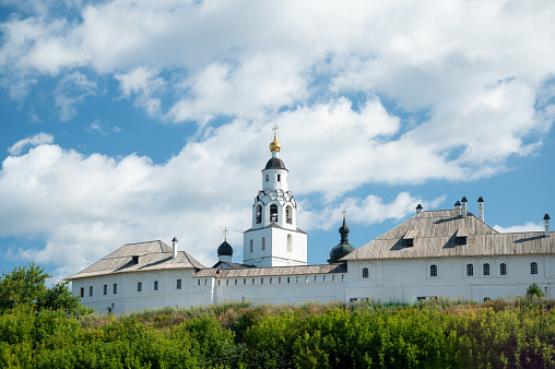 Ivan the Great Bell Tower, with Assumption Belfry on the right on a sunny day with blue sky. Blue sky background with sunbeams. Moscow Kremlin, Russia