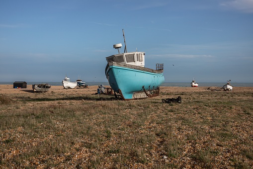 A scenic view of a ship wreck on Dungeness Beach in UK