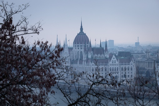 The Parliament Building along the banks of the Danube River in Budapest, Hungary on a cloudy day