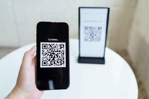 istock Qr code payment. E wallet. Man scanning tag accepted generate digital pay without money.scanning QR code online shopping cashless payment and verification technology concept. 1571327240