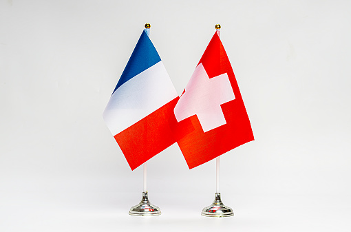 National flags of France and Switzerland on a light background. Flags.
