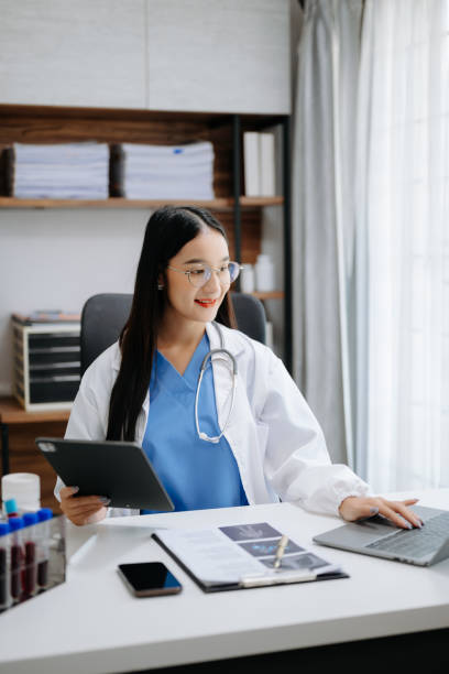 istock Medicine Asian doctor working with modern digital tablet computer interface as medical network concept 1571341344