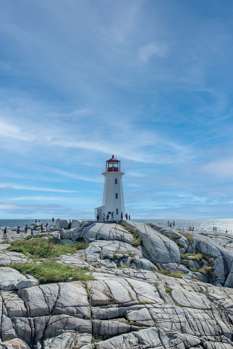Peggy's Cove lighthouse under a blue summer sky, Nova Scotia, Canada.