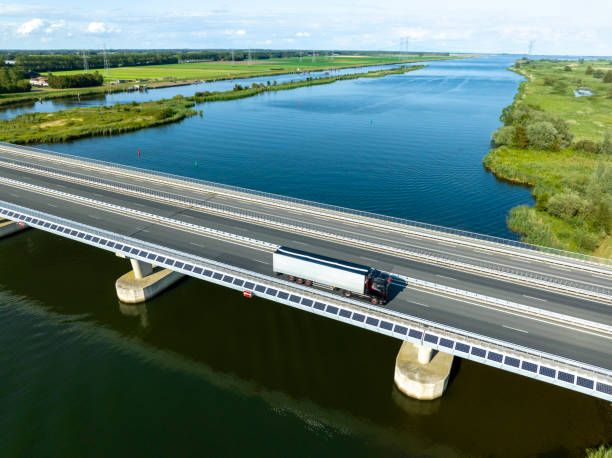 istock Traffic driving over a bridge over a lake in a nature reserve 1571387593