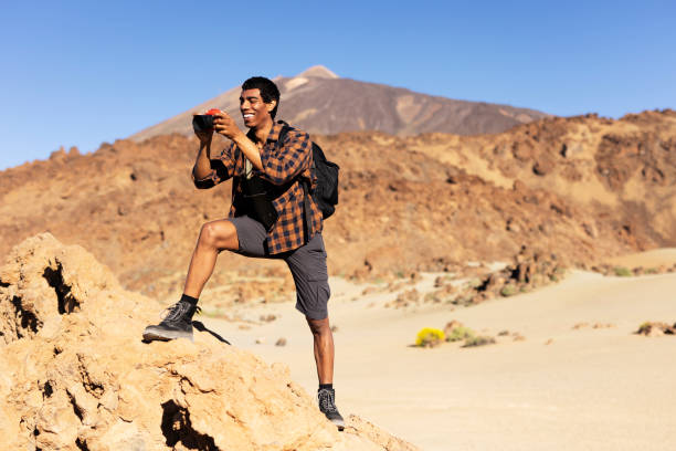 istock Man making memories on the mountain. 1571395748