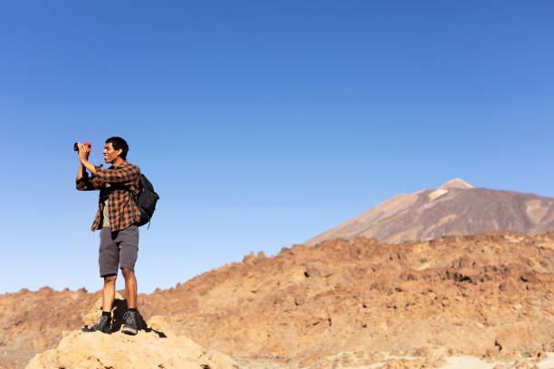 istock Man making memories on the mountain. 1571396281