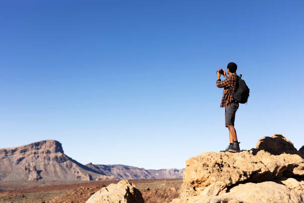istock Man making memories on the mountain. 1571396285
